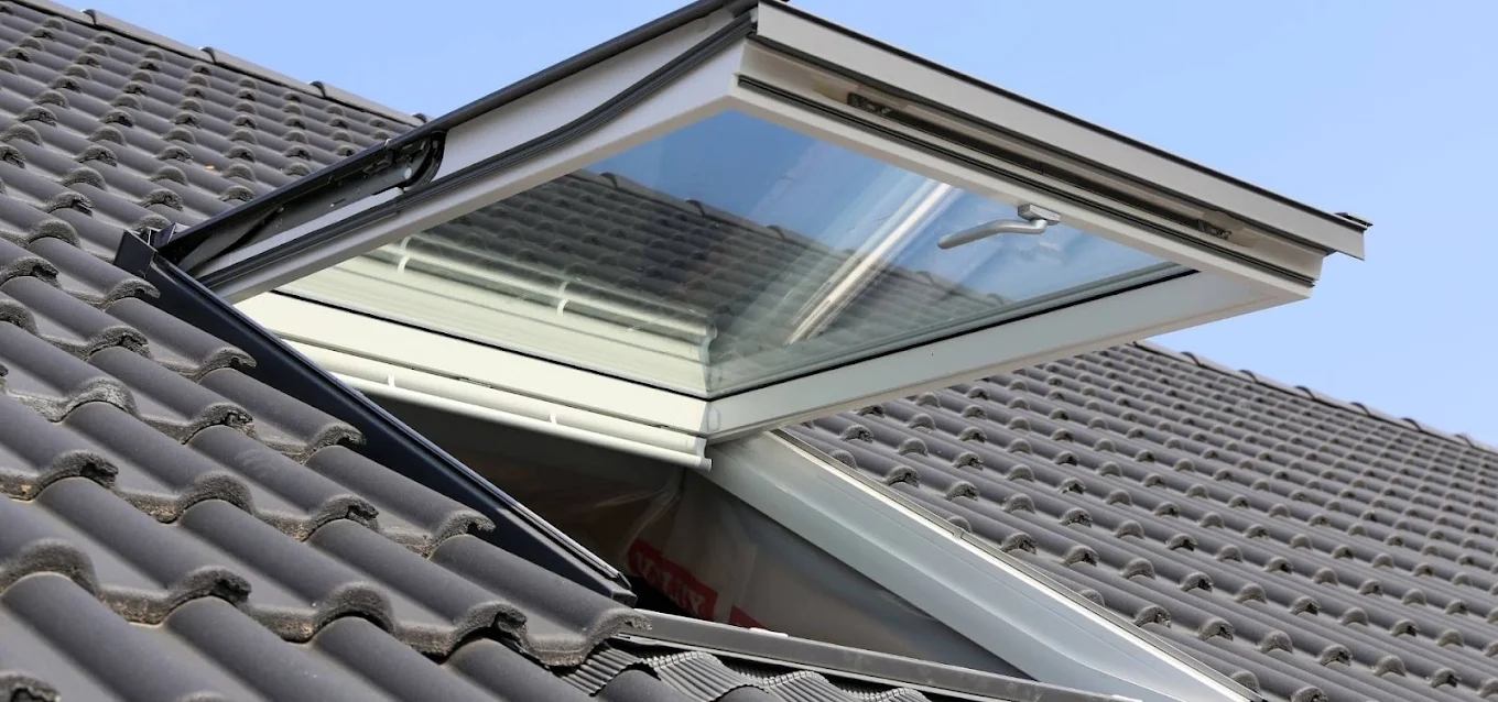 Open Velux skylight installed in a tile roof